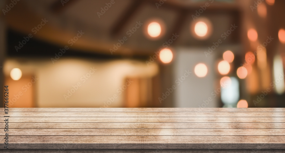 Empty wooden table top with lights bokeh on blur restaurant background
Empty wooden table top with lights bokeh on blur restaurant background