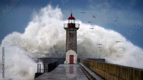 Lighthouse under storm photo