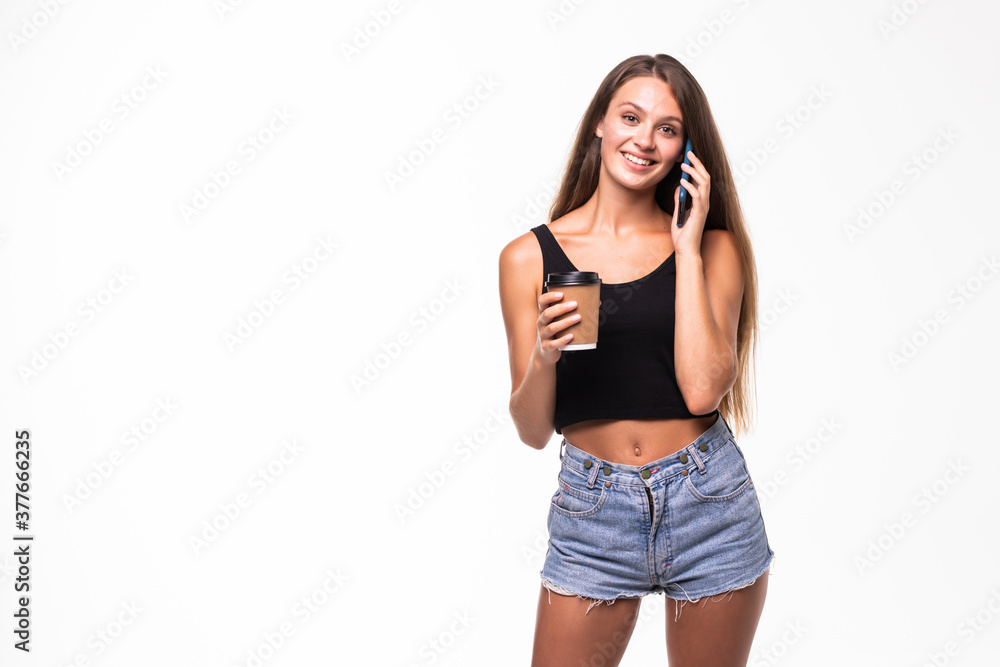Young woman talking on mobile phone while having coffee on white background Young woman talking on mobile phone while having coffee on white background