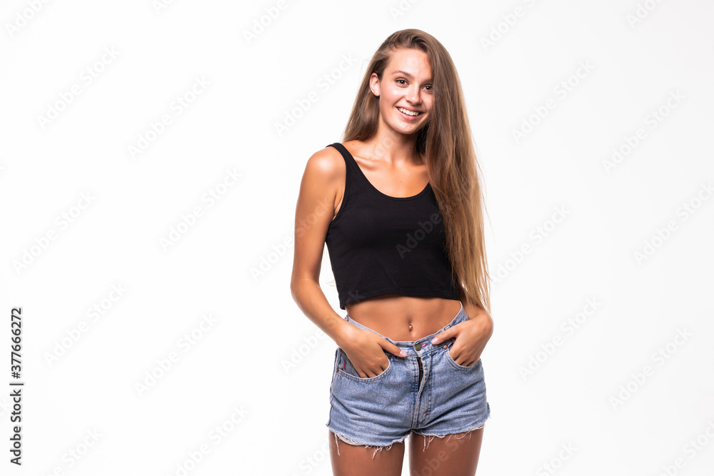 Portrait of sensual woman in shorts and crop top over white background
