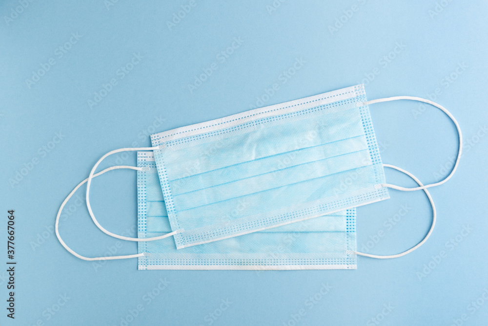 Surgical mask on a blue background. Coronavirus protection concept (COVID19). Surgical mask on a blue background. Coronavirus protection concept (COVID19).