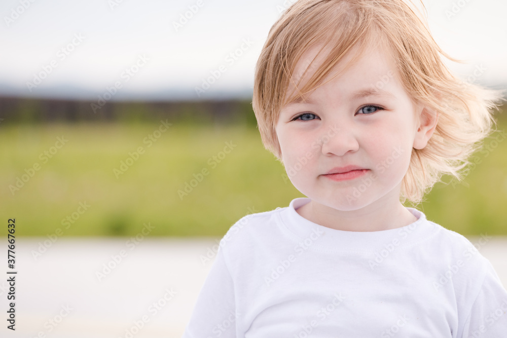 Bored child girl in white tshirt on summer day. Bored child girl in white tshirt on summer day.