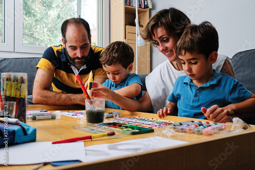 a family painting and playing with their kids