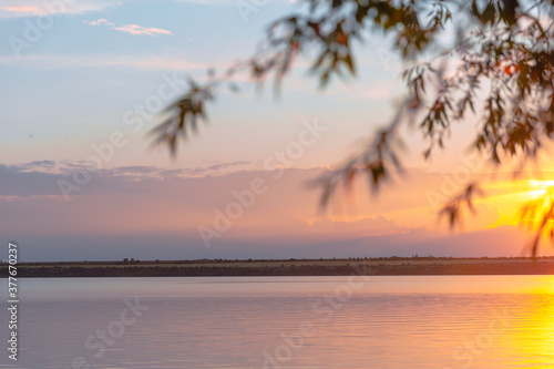 colored sunset over the river, with sky reflection