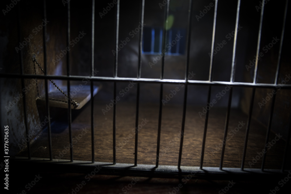 Jail or prison cell. Old grunge prison miniature. Dark prison interior creative decoration. Empty cell. Selective focus Obsolete gray grunge concrete room. Jail or prison cell. Old grunge prison miniature. Dark prison interior creative decoration. Empty cell. Selective focus Obsolete gray grunge concrete room.