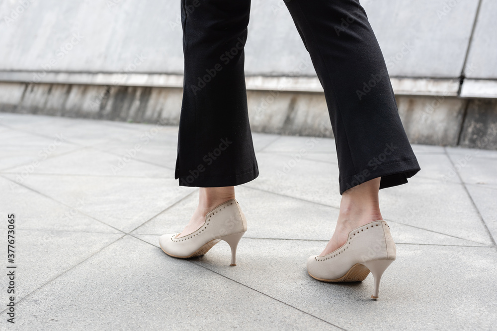 Close-up of walking feet in high heels