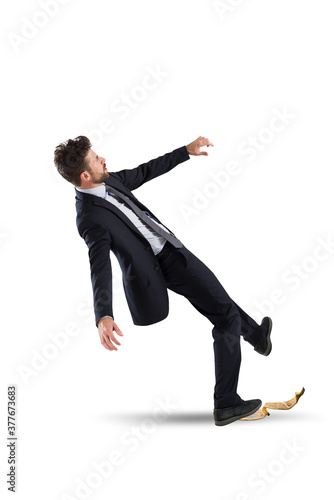 Fotografi Businessman slips on a banana peel