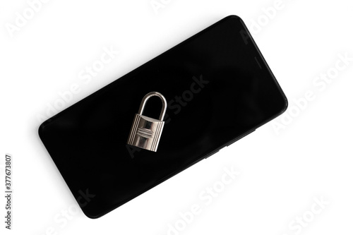 Padlock on the top of a mobile phone isolated on white. View from above. Data security concept.