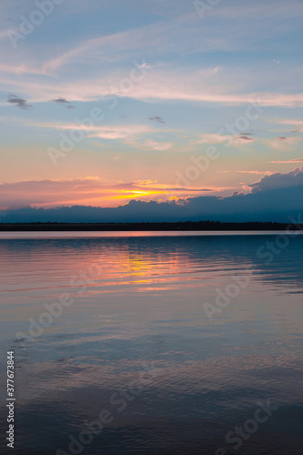 colored sunset over the river, with sky reflection © spaceneospace