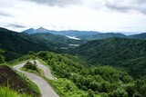 The view of Japanese valley with roadway and lake.