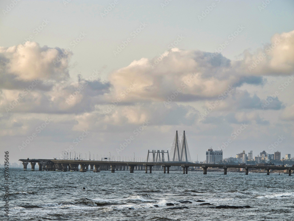Fototapeta premium Mumbai skyline near Ocean with dramatic blue sky and clouds, India 