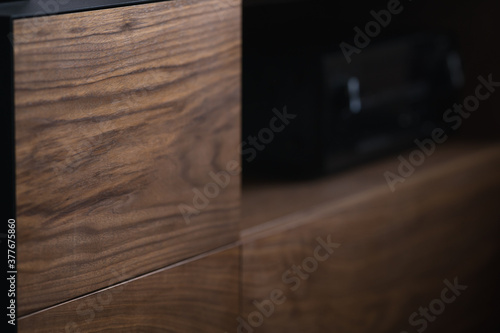 Fényképezés Closeup details of modern tv stand made from walnut and powder coated steed