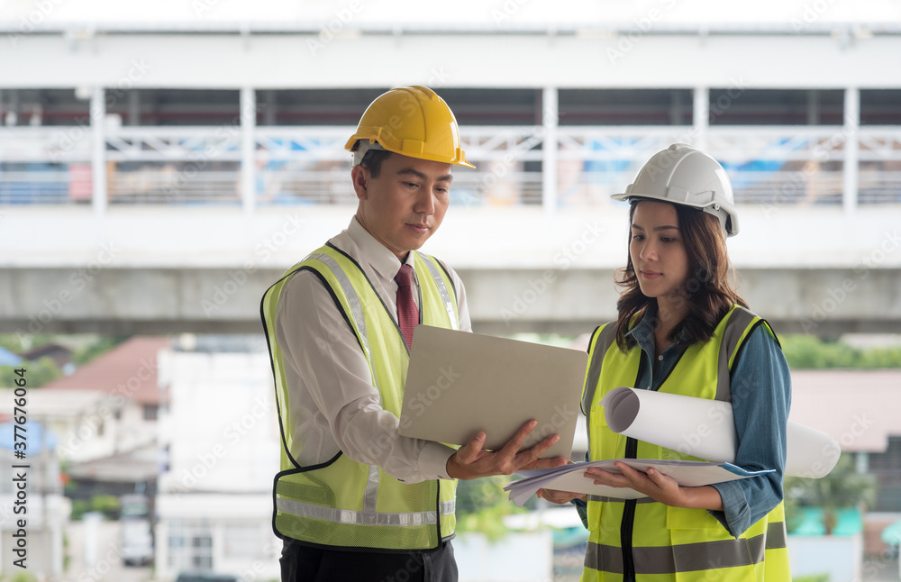 Engineer team discuss and planning from work site about construction building project with blueprint drawing paper. Copy space on left side. Engineer team discuss and planning from work site about construction building project with blueprint drawing paper. Copy space on left side.