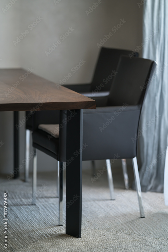 Minimalist kitchen interior with walnut dining table and leather arm chairs Minimalist kitchen interior with walnut dining table and leather arm chairs