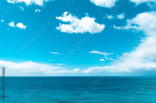 Blue calm ocean in sunny day with bright turquose sky clear horizon  with white clouds view from above from hill in state Victoria Melbourne Australia holiday concept ocean background photo