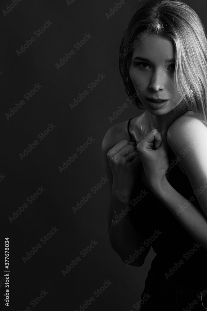 Girl on a black background in fashionable clothes Girl on a black background in fashionable clothes