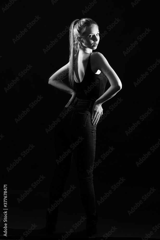 Girl on a black background in fashionable clothes Girl on a black background in fashionable clothes
