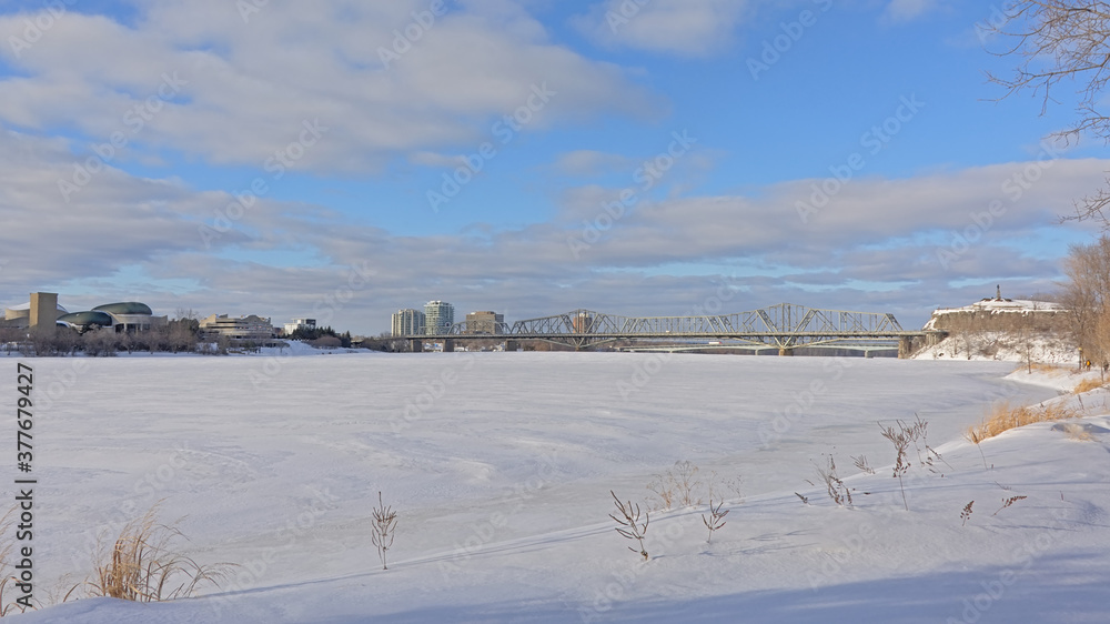 Frozen Ottawa river with cities of Ottawa and gatineau on the embankments, conected by Alexandra brdige. Canada. Panoramic view 