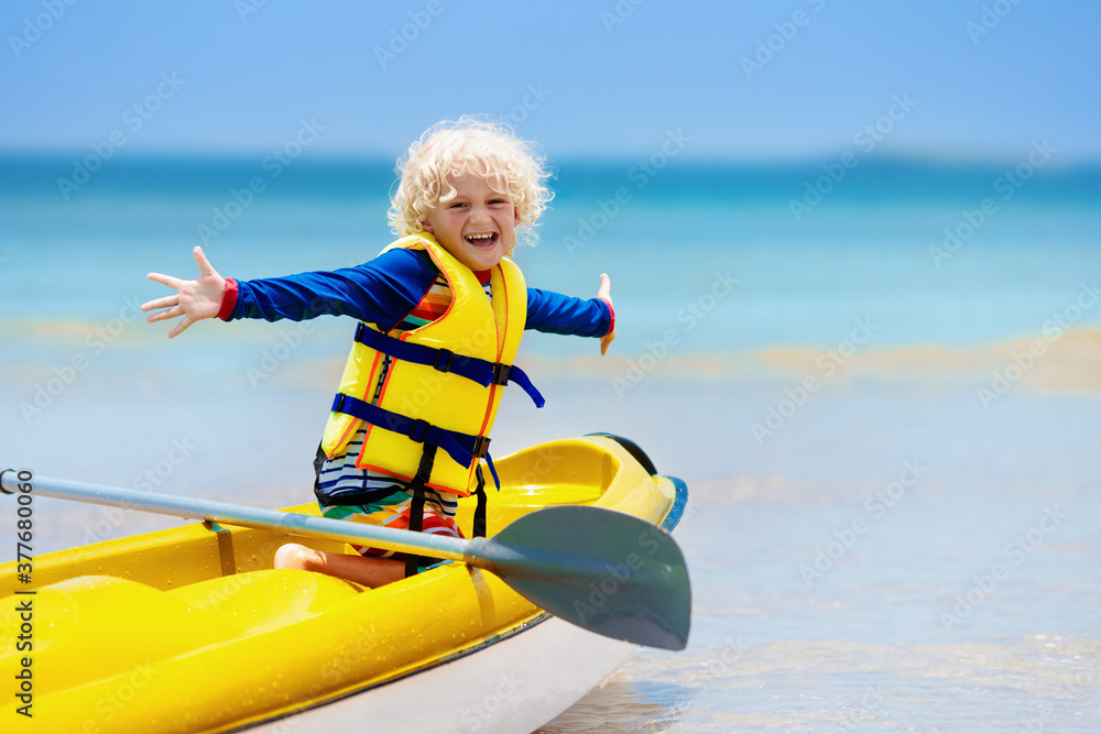 Obraz premium Kids kayaking in ocean. Children in kayak in tropical sea