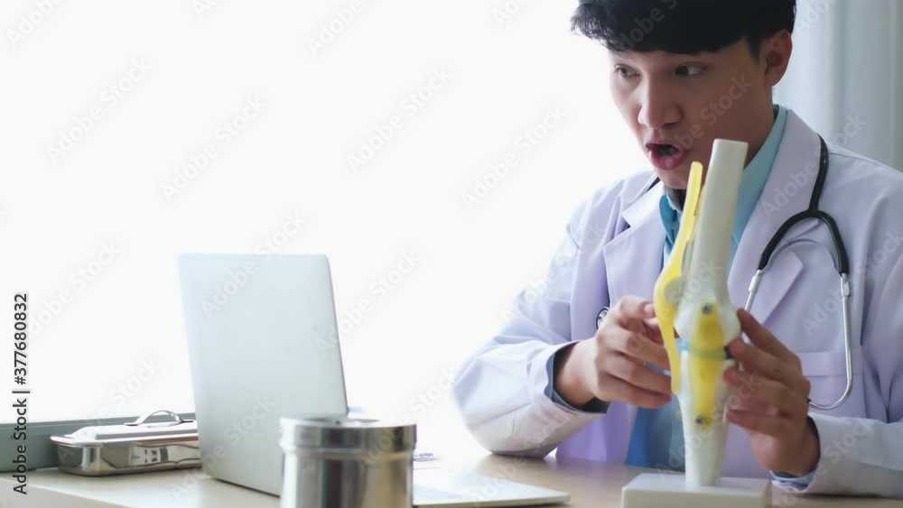 Professional male doctor imedical assistant wears white coat, headset video calling distant patient on laptop. Doctor talking to client using virtual chat computer app. Telemedicine. Professional male doctor imedical assistant wears white coat, headset video calling distant patient on laptop. Doctor talking to client using virtual chat computer app. Telemedicine.