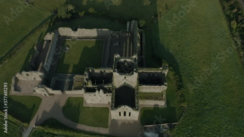 Aerial view, tilt down,  Dunbrody Abbey is a former Cistercian monastery in County Wexford, Ireland. The cross-shaped church was built in the 13th century, and the tower was added in the 15th century. photo