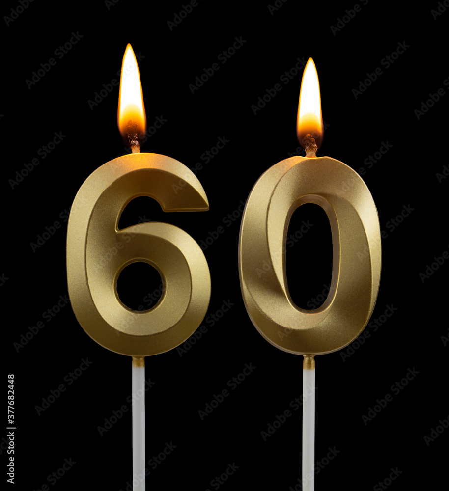 Burning golden birthday candles isolated on black background, number 60 Burning golden birthday candles isolated on black background, number 60