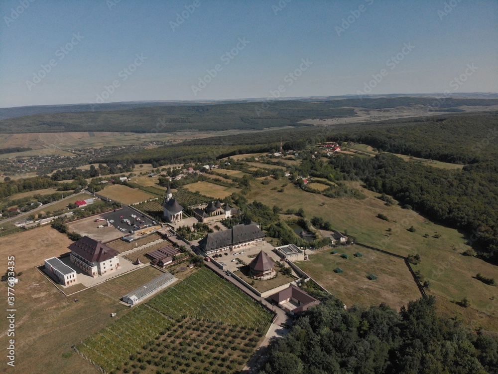 Monastery on  hill with forest from drone