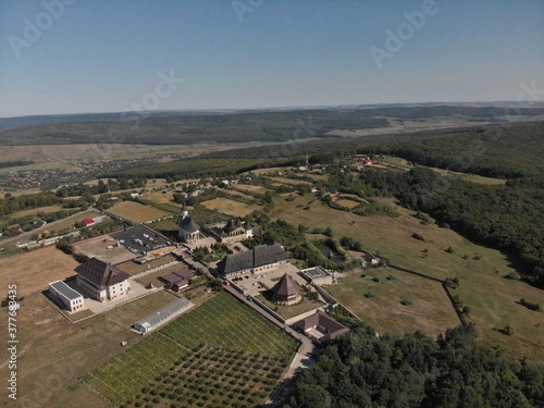 Monastery on hill with forest from drone