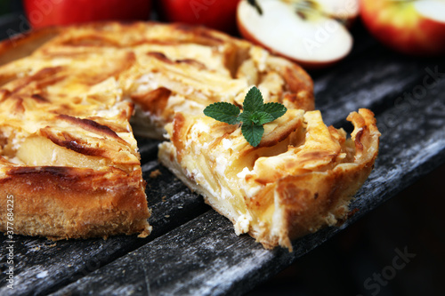 Apple tart. Gourmet traditional holiday apple pie sweet baked dessert food with cinnamon and apples on table
