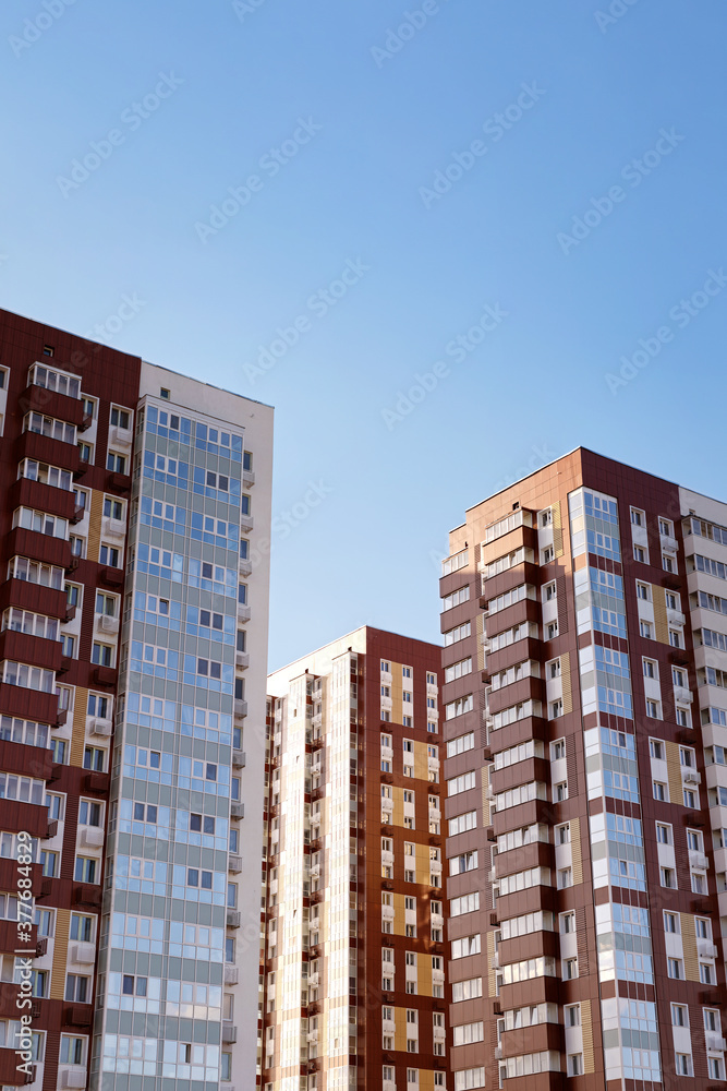 Modern high-rise residential buildings against the blue sky. High resolution image. Copyspace.