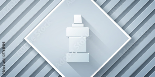 Paper cut Plastic bottle for laundry detergent, bleach, dishwashing liquid or another cleaning agent icon isolated on grey background. Paper art style. Vector.