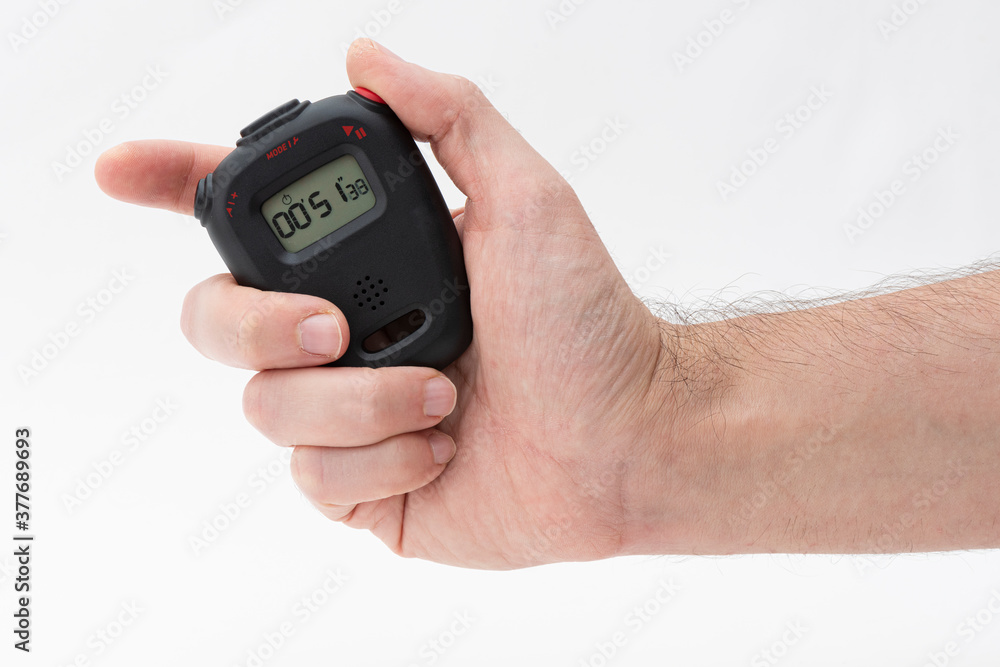Man holding digital stopwatch on the white background.
Man holding digital stopwatch on the white background.