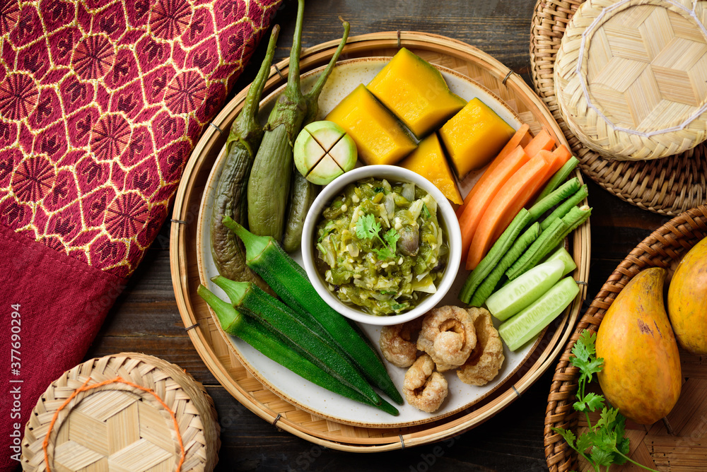 Northern Thai food (Nam Prik Num), Spicy young green chili dip eating with boiled vegetables, fresh vegetables, pork rind and sticky rice, Local Thai food Northern Thai food (Nam Prik Num), Spicy young green chili dip eating with boiled vegetables, fresh vegetables, pork rind and sticky rice, Local Thai food