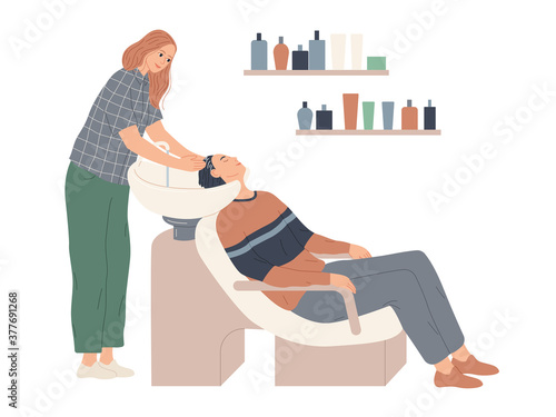 The hairdresser washes her client s hair in preparation for the haircut