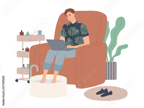A man soaks his legs in a bowl of water while waiting for a spa treatment