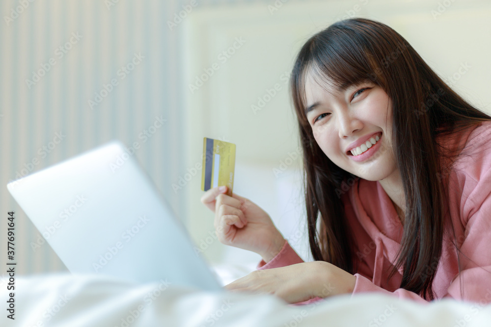 Young Asian woman holding credit card