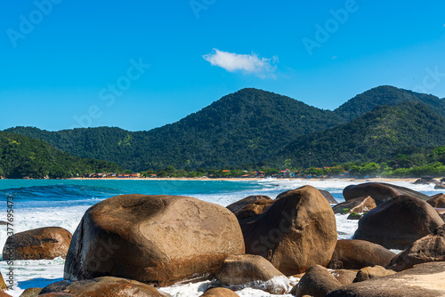 Beautiful tropical landscape in Brazil, with mountains, forest, beach and big rocks in the ocean