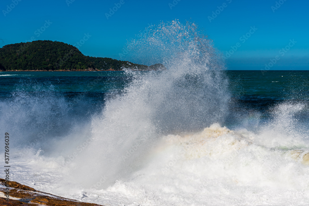 Big splash of white wave foam in brazilian beach