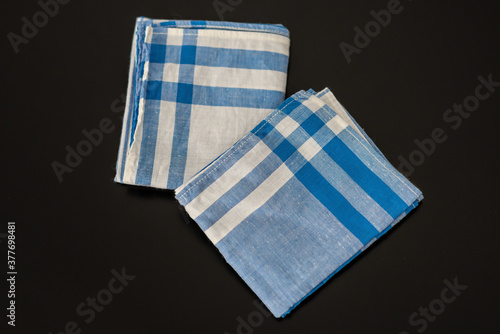 Men’s white blue handkerchief on a black background. 