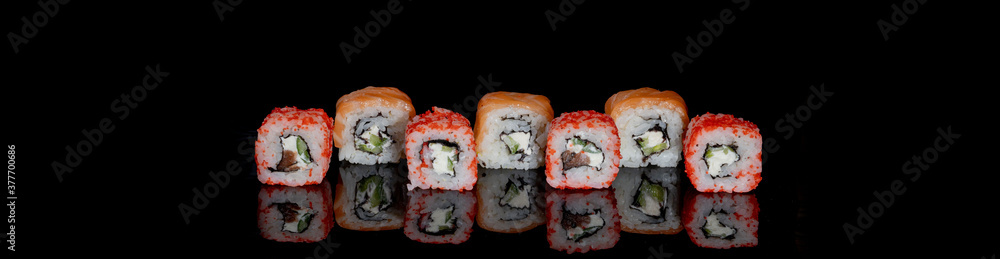 Philadelphia roll with salmon, cheese and cucumber on a black background with reflection. Sushi Philadelphia Philadelphia roll with salmon, cheese and cucumber on a black background with reflection. Sushi Philadelphia