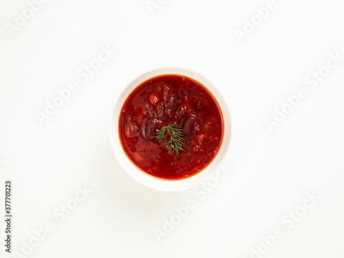 red bean soup in a white bowl on a white table, borsch, top view