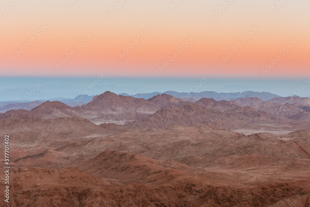Gold sunset arid desert landscape with mountains silhouette Sinai, Egypt