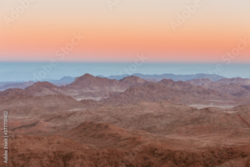 Gold sunset arid desert landscape with mountains silhouette Sinai, Egypt