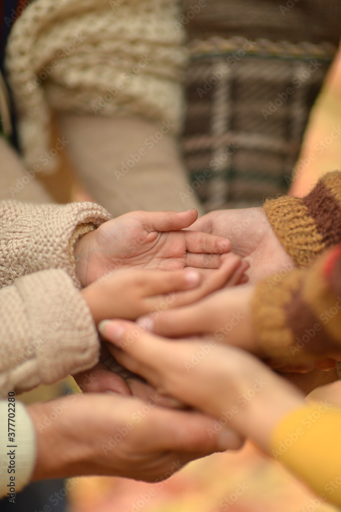 Cropped image, family putting hands together close up Cropped image, family putting hands together close up
