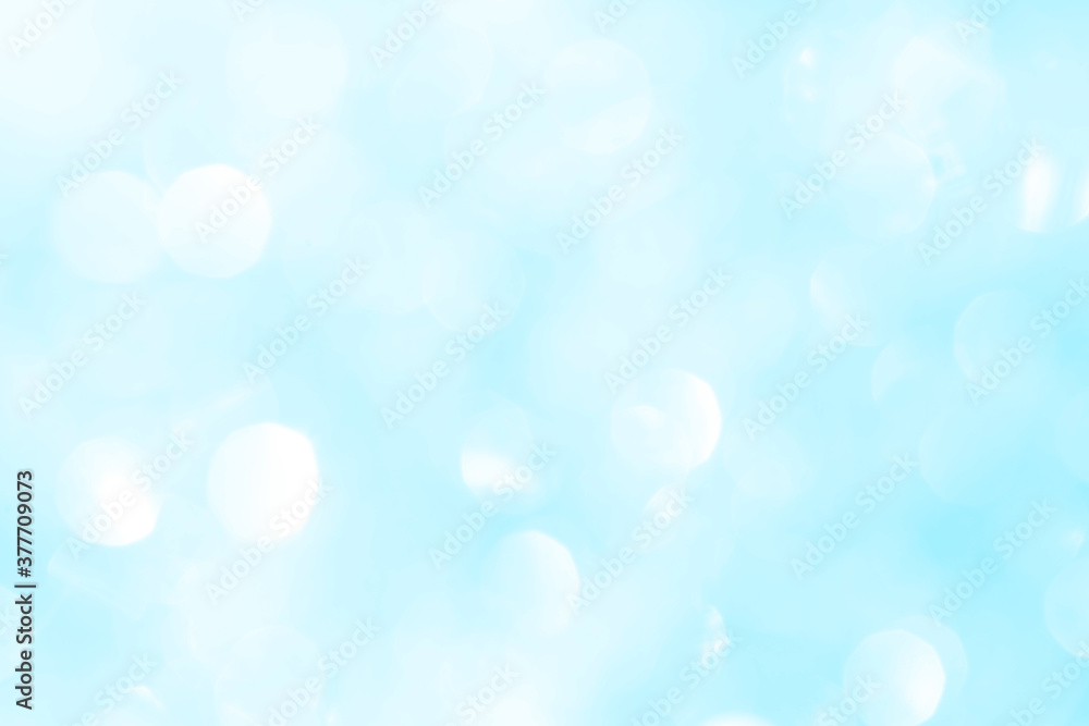 Bokeh light on blue background, sky with circle glitter light blue. Snow abstract soft glowing with vivid bright light and bokeh blur effect. 