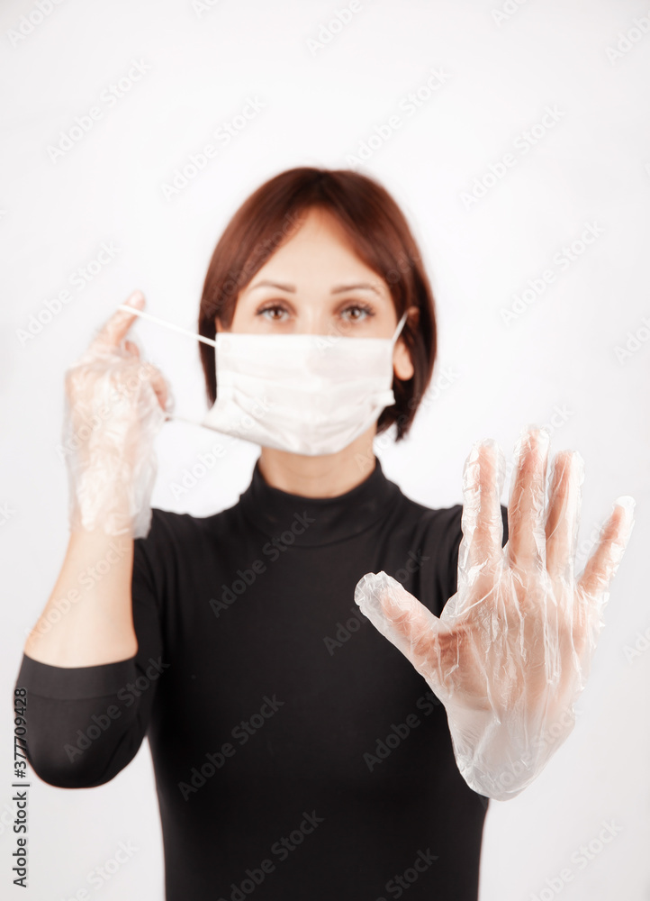young beautiful woman in protective mask and transparent disposable gloves, isolate on white background young beautiful woman in protective mask and transparent disposable gloves, isolate on white background