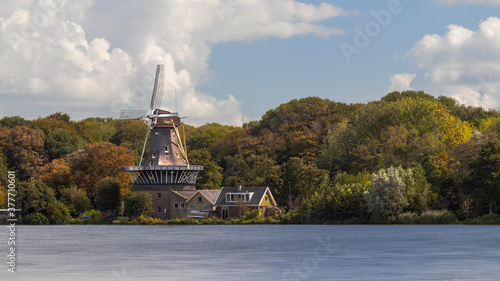 View of windmill The Star on the Kralingse Plas in Rotterdam om a beautiful late summer day photo