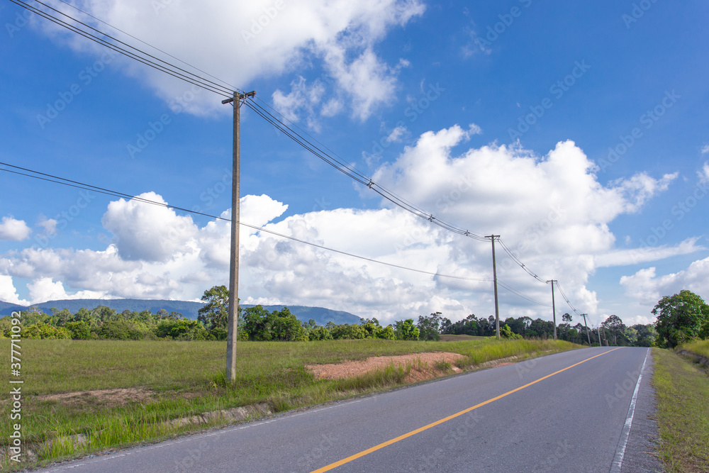 Empty asphalt road with electricity post on countryside Empty asphalt road with electricity post on countryside