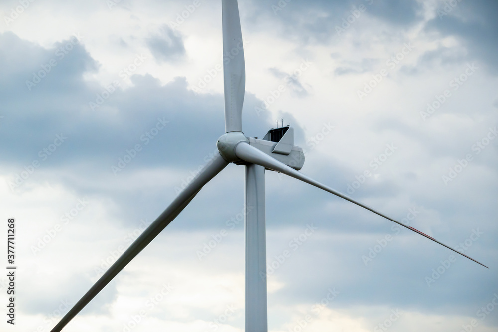 Fragment of a three-bladed wind generator against a cloudy sky, copy space. Fragment of a three-bladed wind generator against a cloudy sky, copy space.