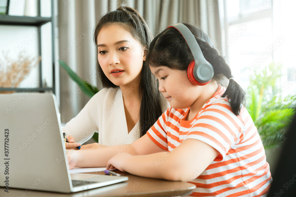 asian mother enjoy teach and explain homework to child daughter for online study during homeschooling at home ,home quarantine, online learning new normal lifestyle asian mother enjoy teach and explain homework to child daughter for online study during homeschooling at home ,home quarantine, online learning new normal lifestyle